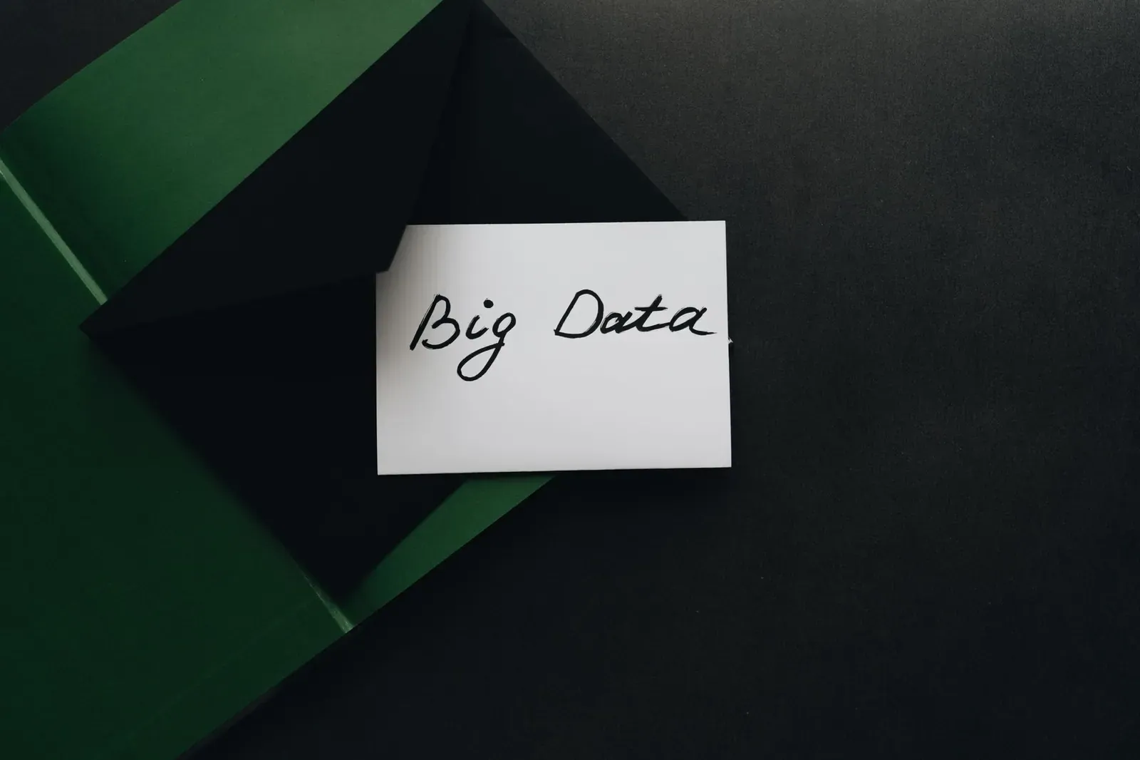 Une photo minimaliste d'une carte avec le texte 'Big Data' à l'intérieur d'une enveloppe verte